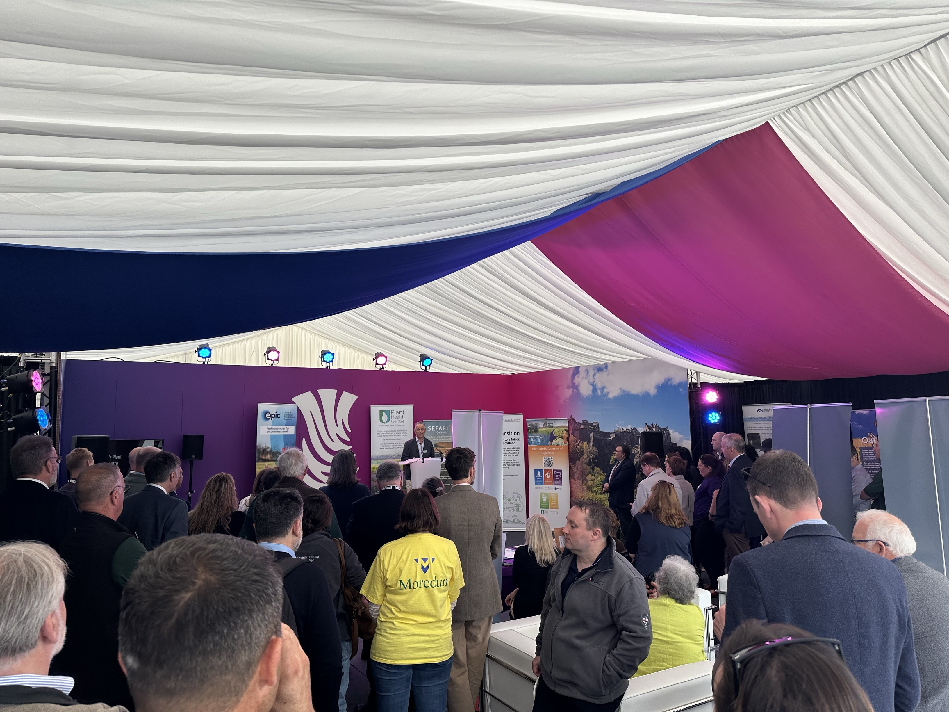 Audience listening to Plant Health Centre speaker in the Scottish Government marquee.